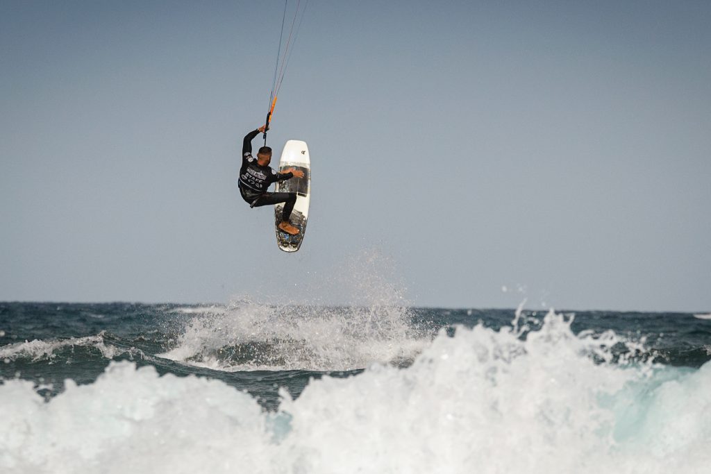 a kiteboarder on the take-off of a trick with a strapless kite board